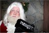 photo of Santa holding a 'Naughty' stocking